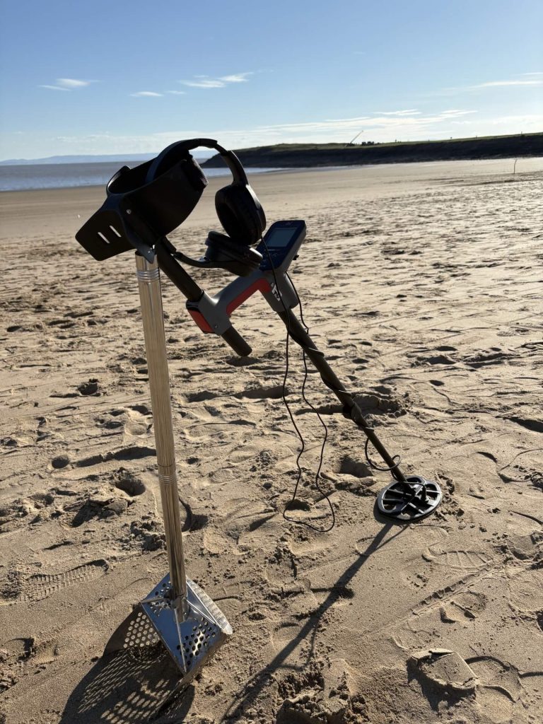minelab vanquish 360 on the beach, set in a stunning background.