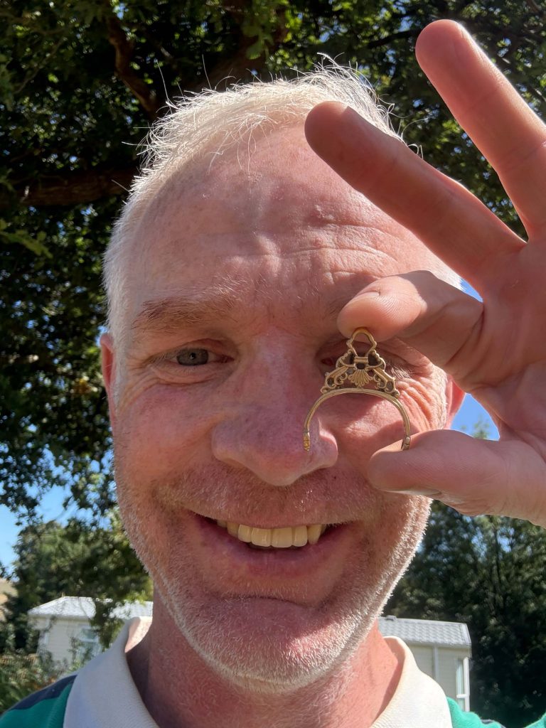 tHE ARTEFACT ADDICT HOLDING A TOP PIECE OF A GOLD GEROGIAN FOB SEAL.