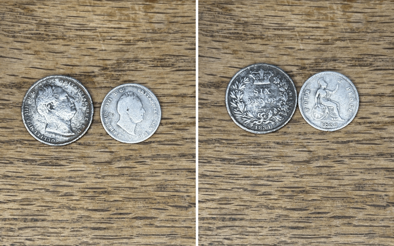 A collection William 4th silver coins displayed on a wooden surface.